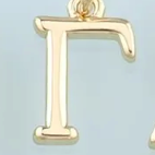 Gold greek letter charm
