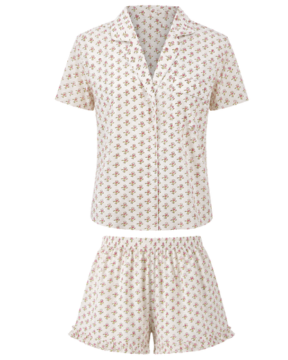 Floral pink block printed patterned pajama shirt and ruffle shorts set on a white background